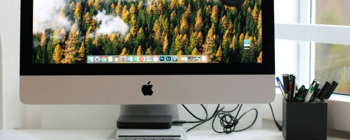 Free Stylish home office workspace featuring a computer setup with accessories. Stock Photo