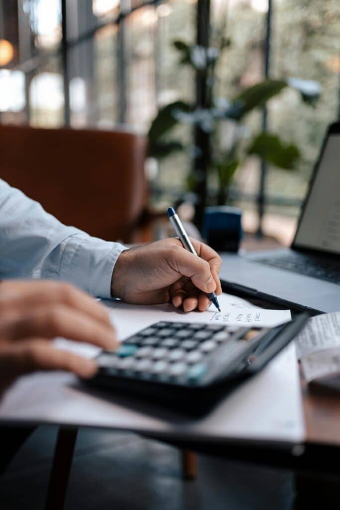 Invest-Smart-Grow-Fast-Your-Small-Business-Guide-to-IT-Expense-Planning-scaled.jpg » Flux Labs - Managed Information Technology Services Free A person calculating finances with a calculator and pen on a desk indoors. Stock Photo