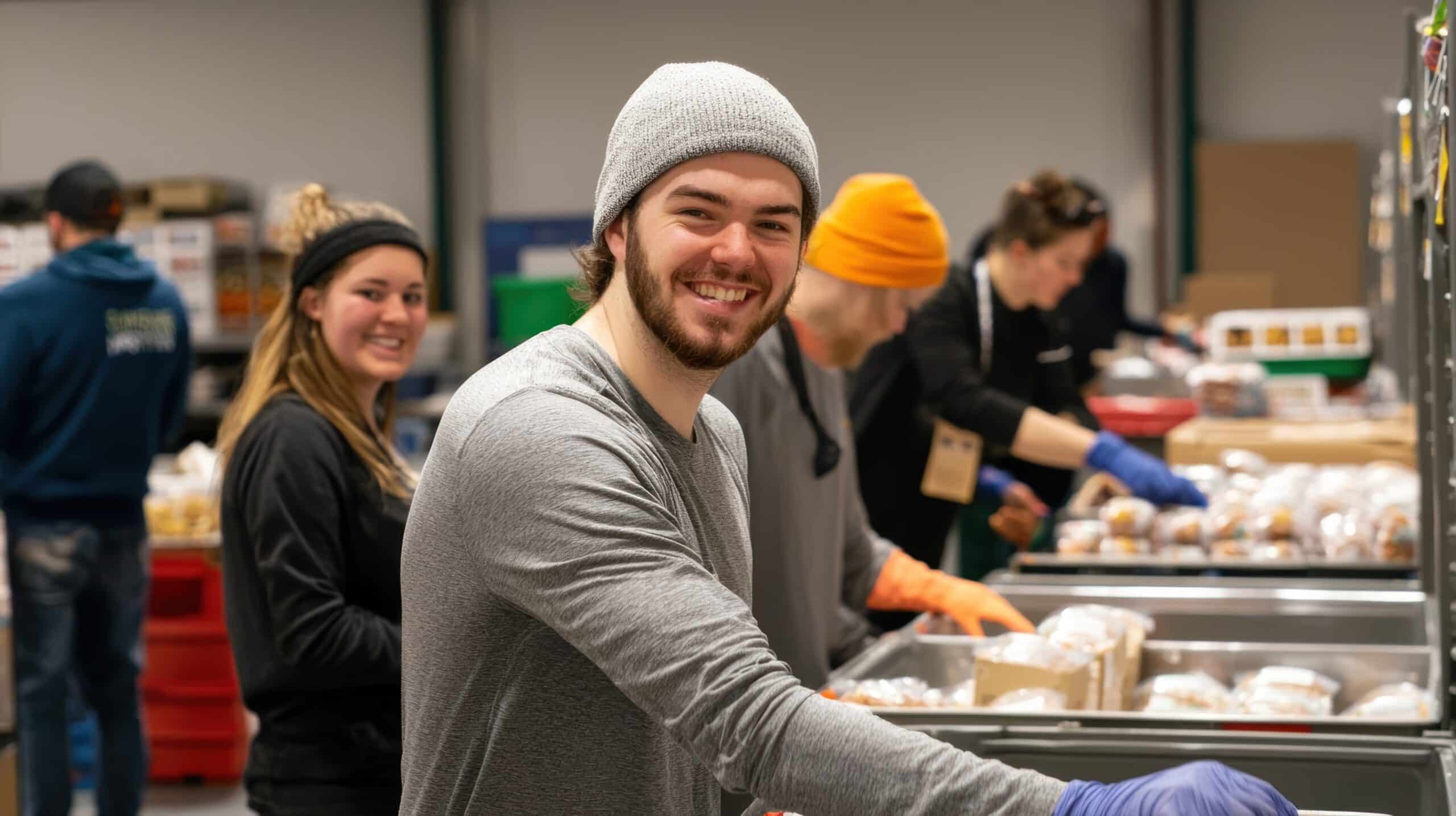 A group of people volunteering at a local food bank » Flux Labs - Managed Information Technology Services