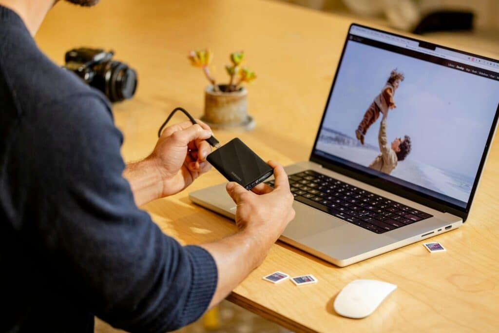 The-_Backup-Exit_-Strategy_-Can-You-Move-Your-Data-Without-the-Vendors-Help_-scaledjpg » Flux Labs - Managed Information Technology Services A man sitting at a table with a laptop and cell phone