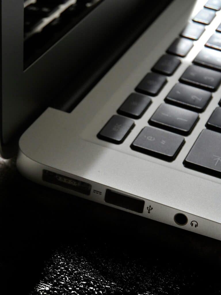 The-Zombie-SaaS-Audit_-Finding-the-3-Apps-Your-Former-Employees-Still-Access-scaledjpg » Flux Labs - Managed Information Technology Services Free Detailed view of a silver laptop showing keyboard and multiple ports. Stock Photo