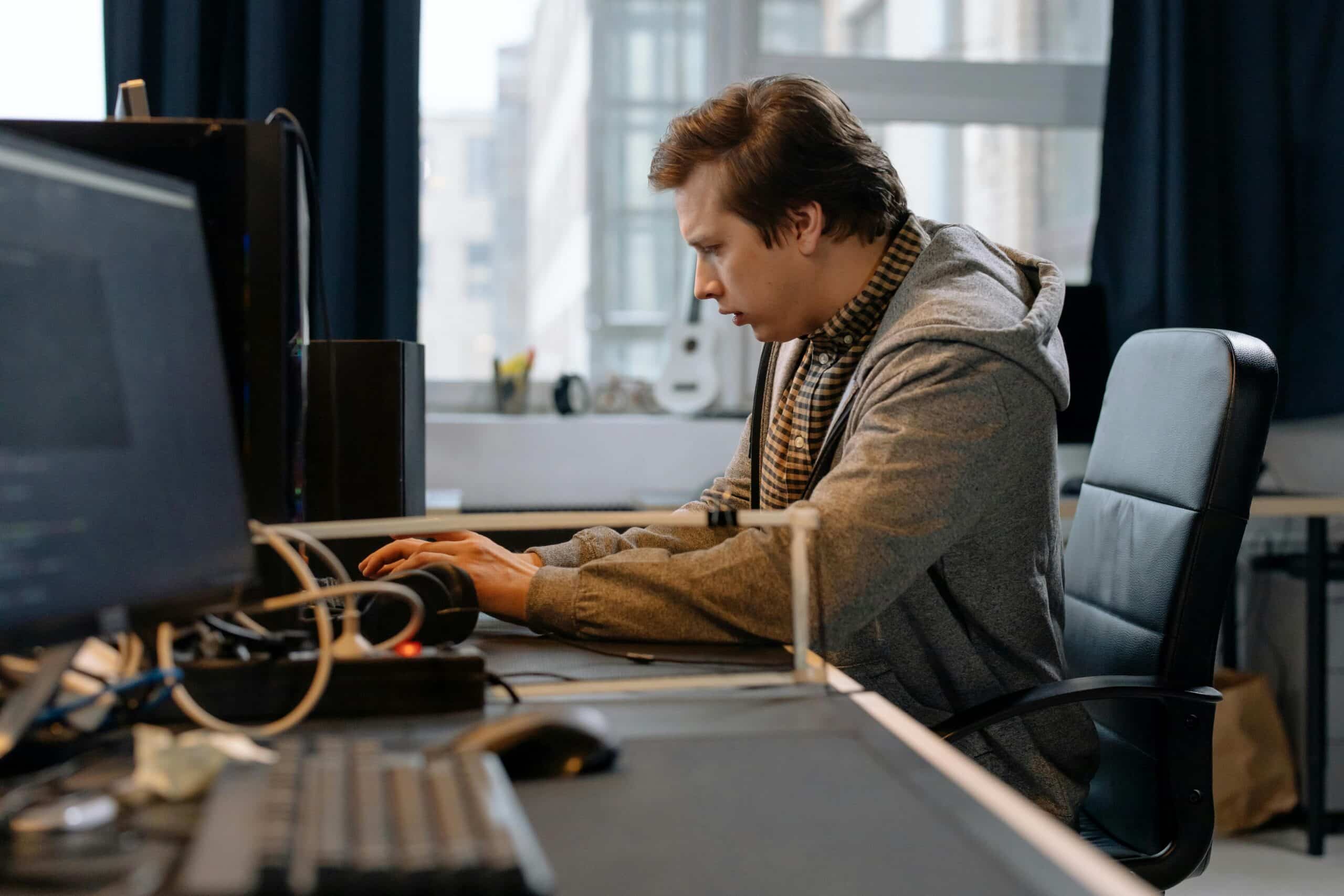 pexels-cottonbro-6803531-scaledjpg » Flux Labs - Managed Information Technology Services Free A concentrated professional working at a computer in a modern office setting. Stock Photo