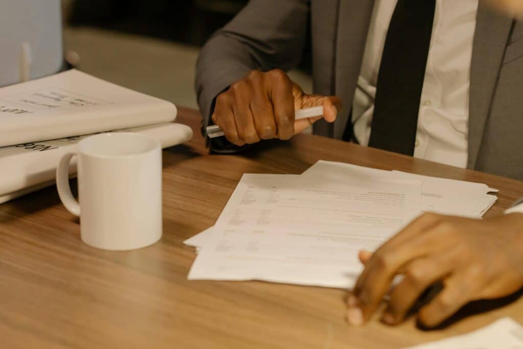 pexels-cottonbro-8369207-scaledjpg » Flux Labs - Managed Information Technology Services Free Close-up of a businessman holding and reviewing documents on a wooden desk. Stock Photo
