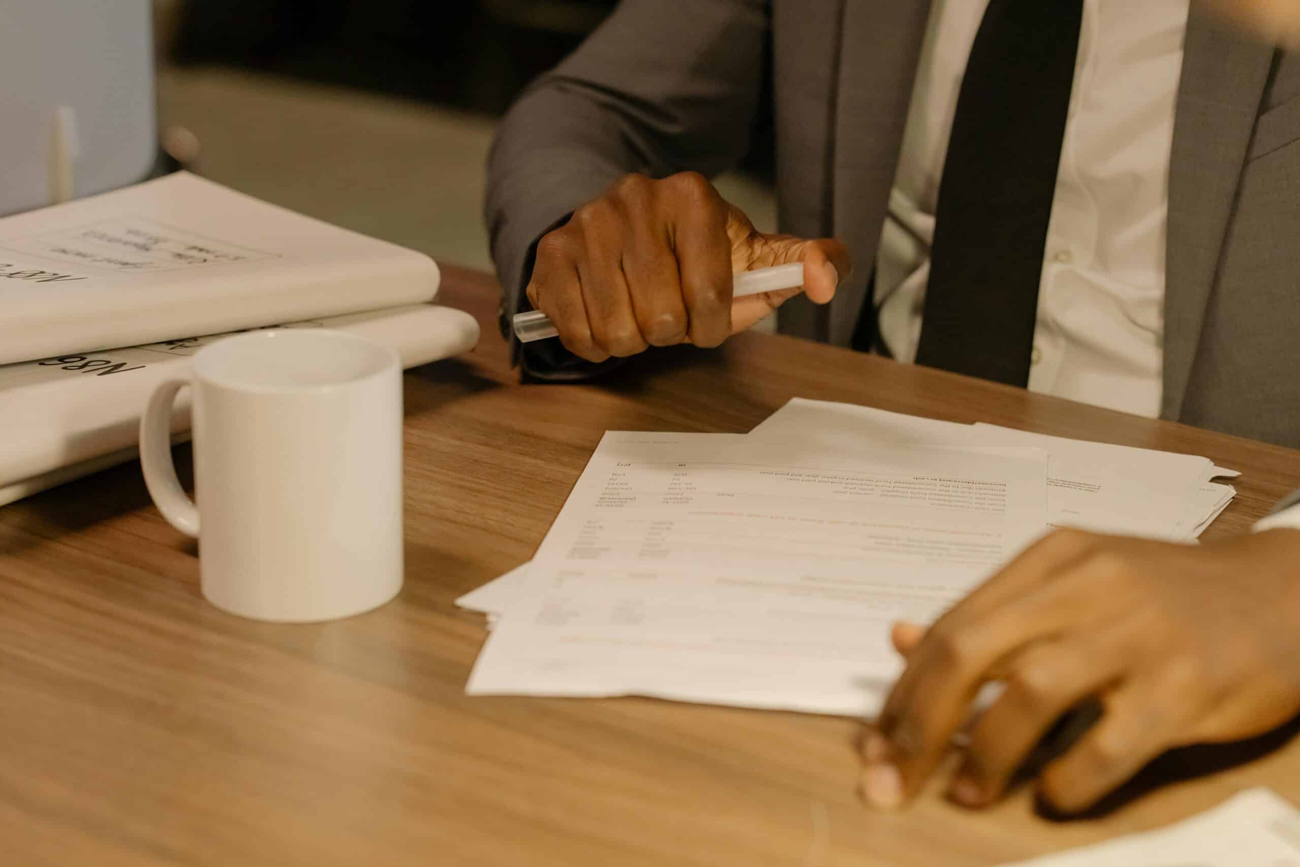 pexels-cottonbro-8369207-scaledjpg » Flux Labs - Managed Information Technology Services Free Close-up of a businessman holding and reviewing documents on a wooden desk. Stock Photo