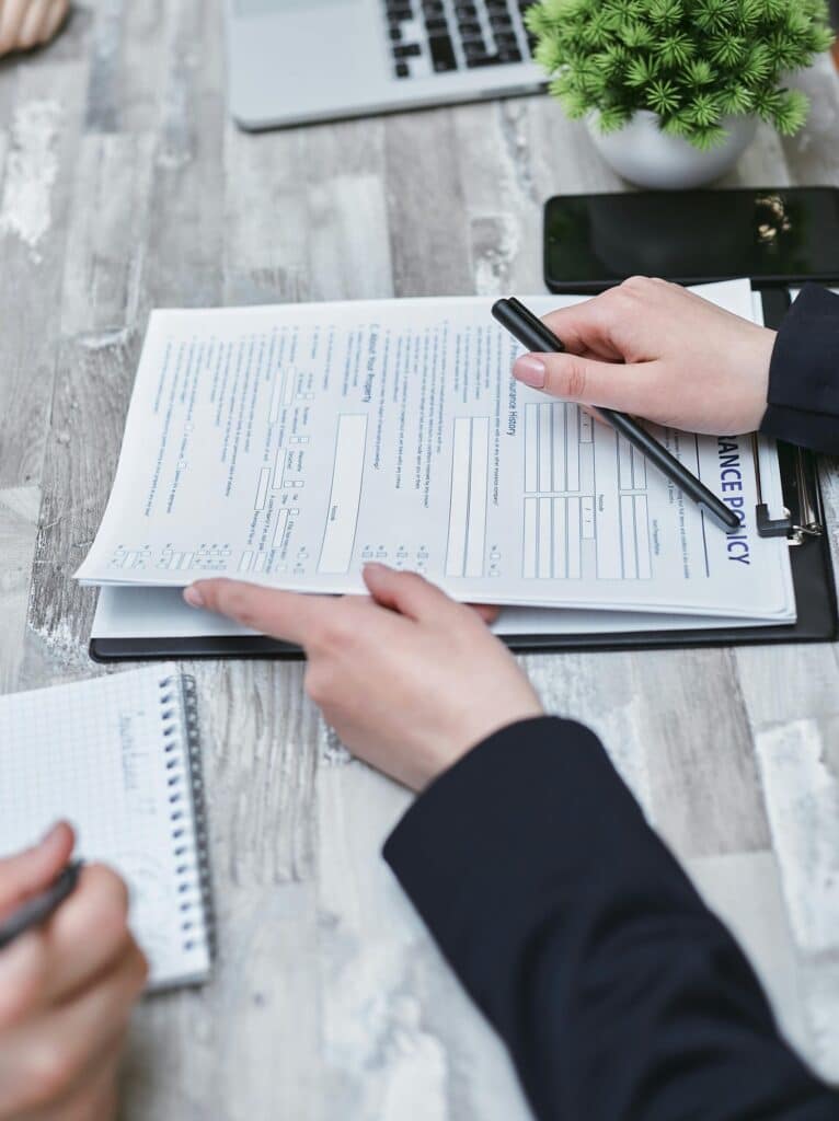 pexels-mikhail-nilov-7731326-scaledjpg » Flux Labs - Managed Information Technology Services Free Close-up of hands analyzing insurance policy paperwork with pen on table. Stock Photo