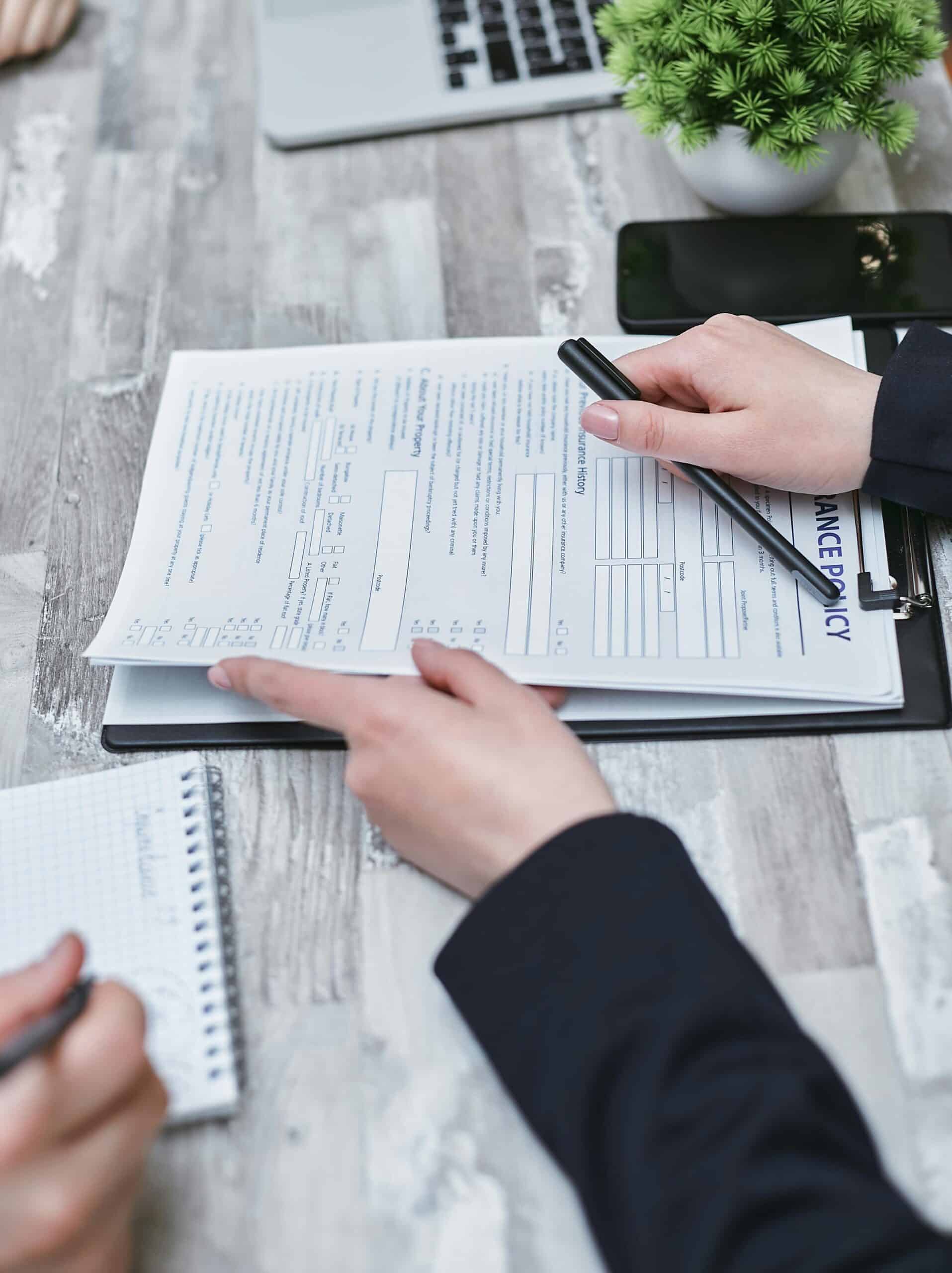 pexels-mikhail-nilov-7731326-scaledjpg » Flux Labs - Managed Information Technology Services Free Close-up of hands analyzing insurance policy paperwork with pen on table. Stock Photo