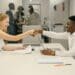 Free Business professionals completing a successful deal with a handshake in a modern office setting. Stock Photo