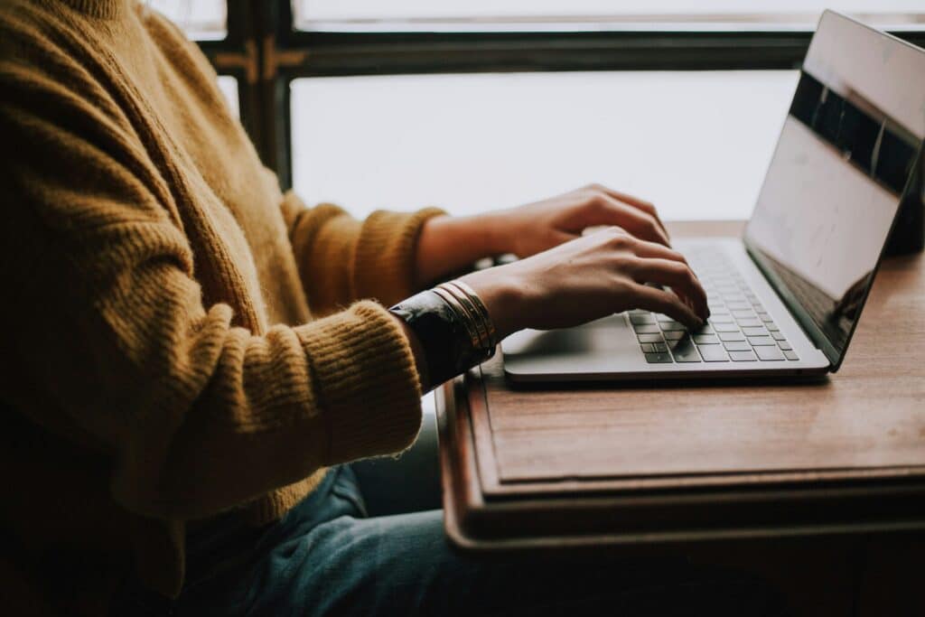 christin-hume-mfB1B1s4sMc-unsplash-scaledjpg | Flux Labs person sitting front of laptop