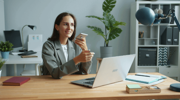 Screenshot-2026-09-02-153612png | Flux Labs lady holding phone while working on a laptop